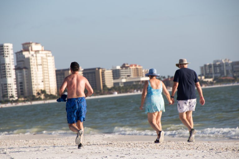 Retired people run and walk on the beach in Florida