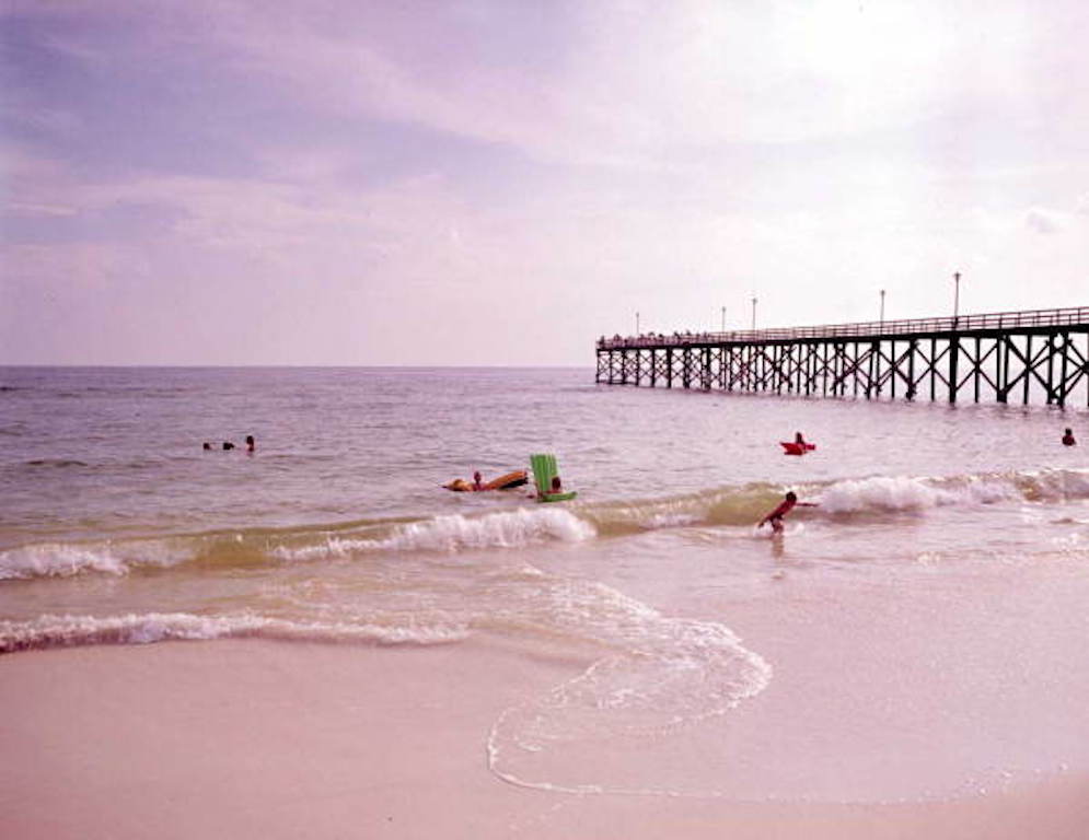 Children playing on the beach in Mexico Beach, Florida, near the fishing pier