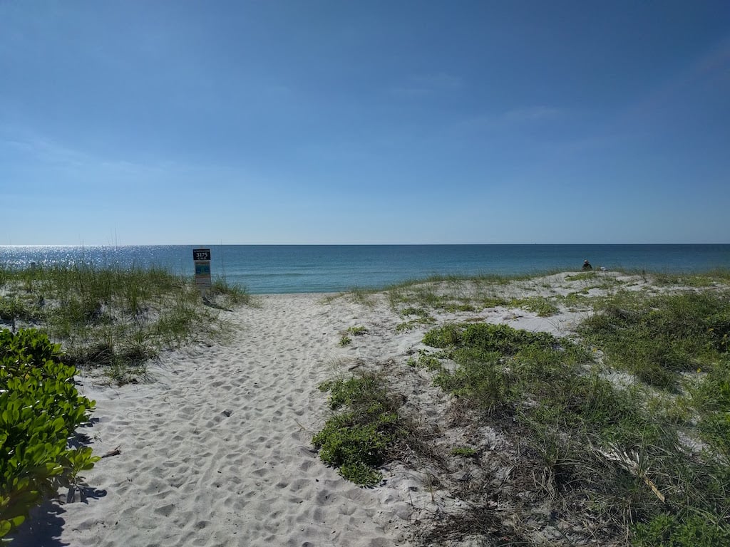 Beach access on Longboat Key with white sand beaches and calm, clear water