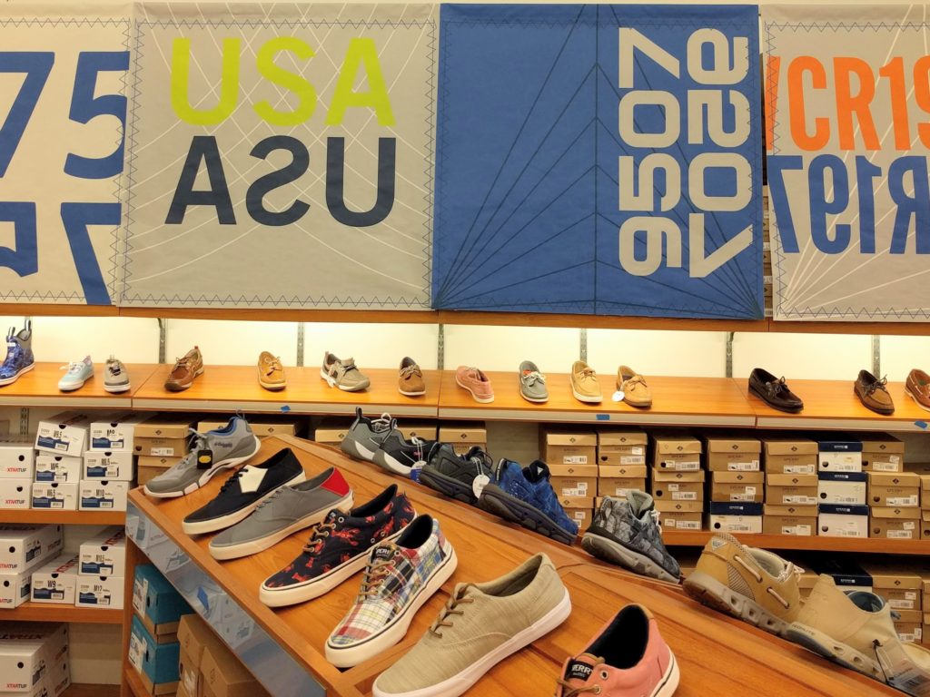 shelves of boat and sailing shoes inside a West Marine store