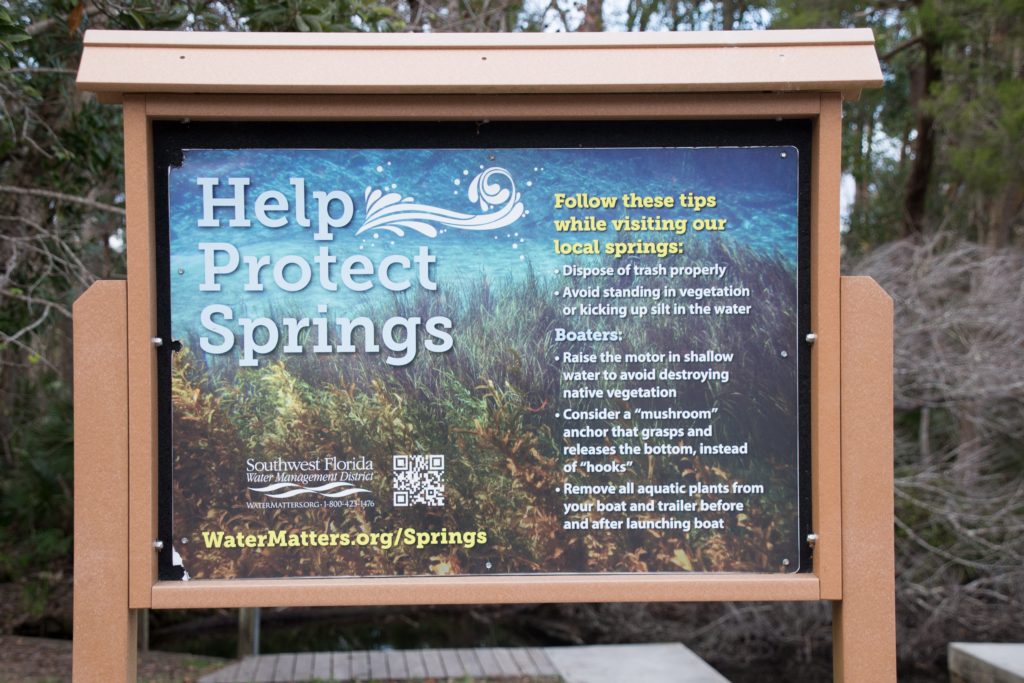 A Southwest Florida Water Management District (SWFWMD) sign about protecting natural springs in Florida