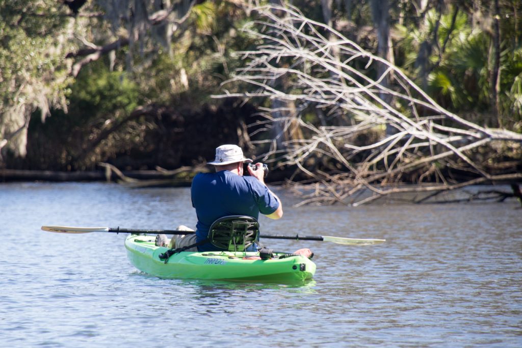 A wildlife photographer kayaking in the Chassahowitzka River, Florida
