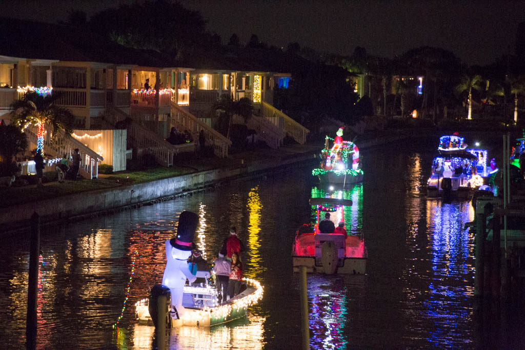 Boats lit up and participating in a Christmas boat parade in Florida