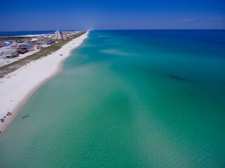 Aerial view of clear water and white sand beach in the Florida Panhandle at Pensacola Beach