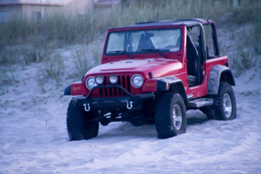 A jeep driving on the beach in Florida