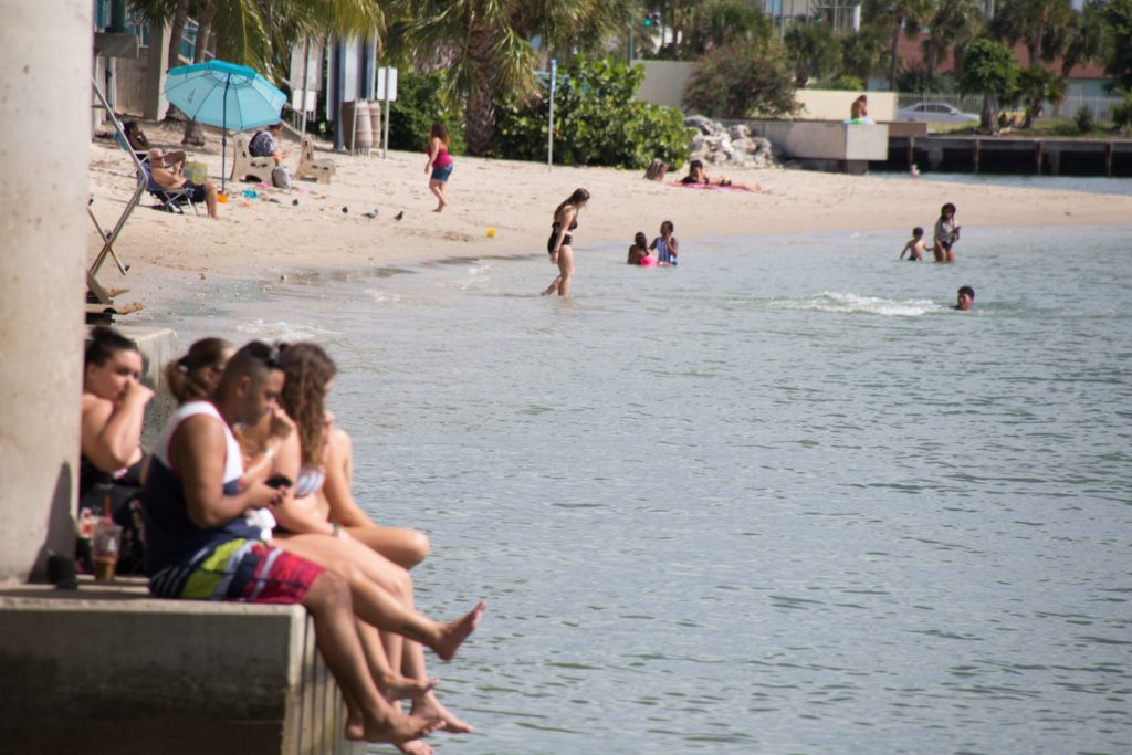 Visitors sit on the bridge near the Phil Foster Snorkel Trail in West Palm Beach, Florida