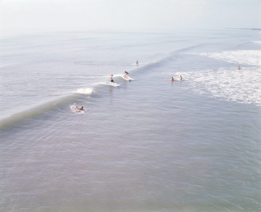 Surfers on a good wave in Cocoa Beach, FL